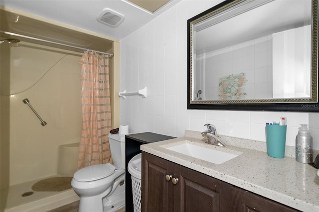 bathroom featuring tile walls, vanity, tasteful backsplash, a shower with curtain, and toilet