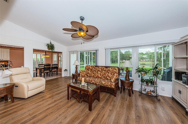 living room with hardwood / wood-style floors, vaulted ceiling, and ceiling fan