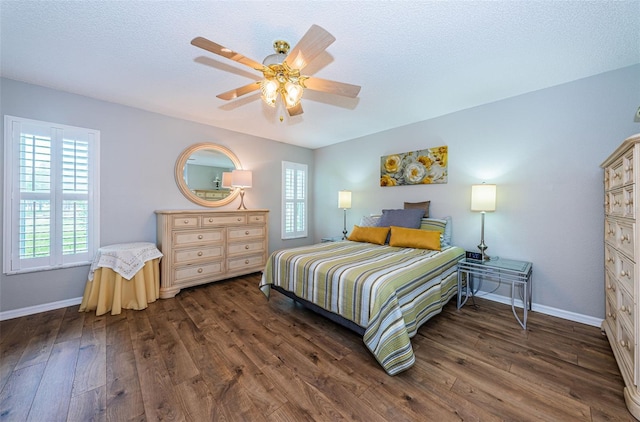 bedroom featuring ceiling fan, a textured ceiling, and dark hardwood / wood-style flooring