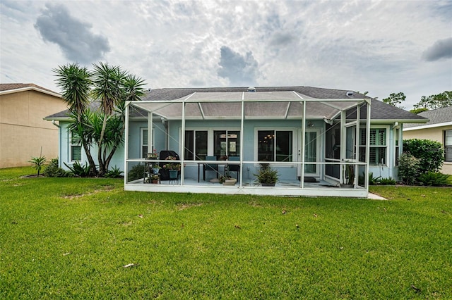 back of house featuring a yard, a patio area, and glass enclosure