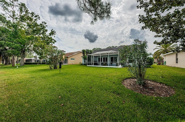 view of yard featuring glass enclosure