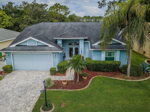 view of front of house featuring a garage and a front lawn