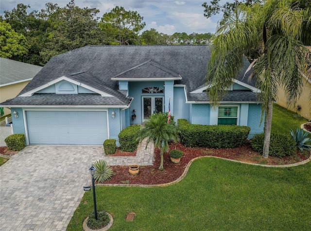 view of front facade featuring a front yard and a garage