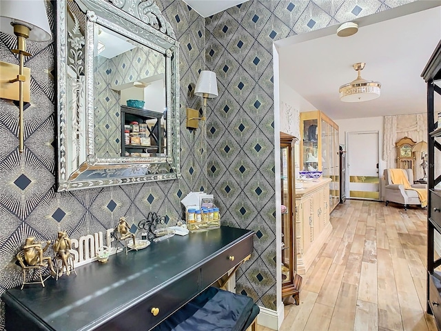hallway with wallpapered walls and hardwood / wood-style flooring