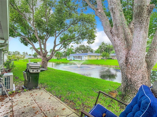 view of grassy yard with a water view