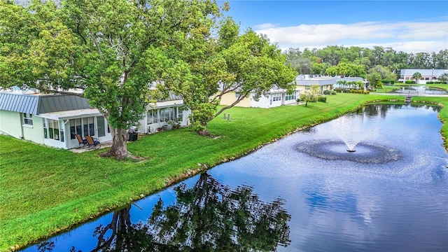 exterior space featuring a water view and a yard