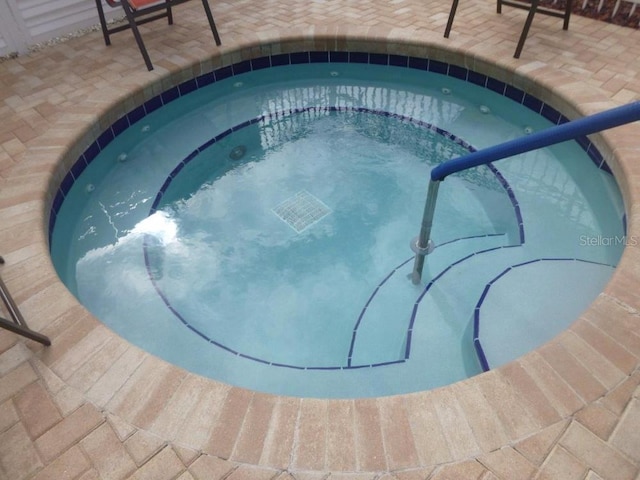 view of swimming pool featuring a community hot tub