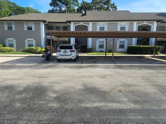 view of building exterior with covered parking