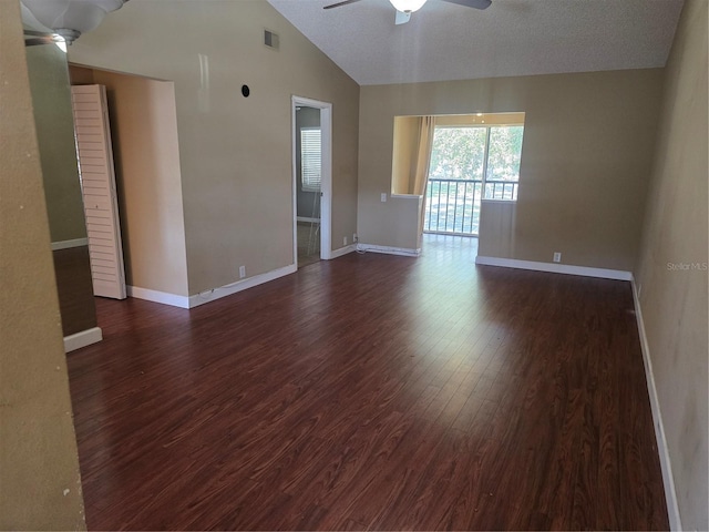 unfurnished room featuring dark wood-type flooring, vaulted ceiling, and ceiling fan