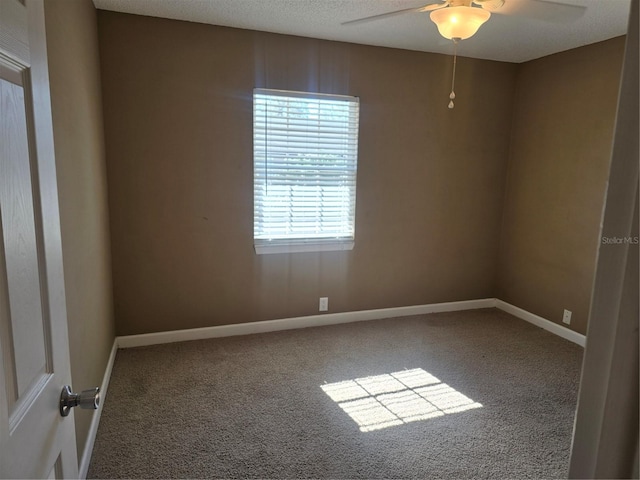 unfurnished room with ceiling fan, carpet, and a textured ceiling