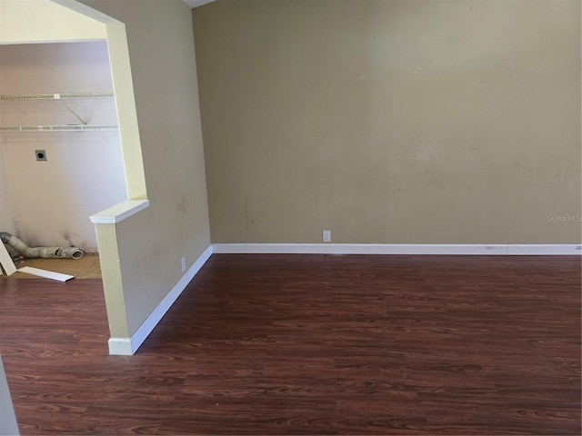 empty room featuring dark wood-type flooring