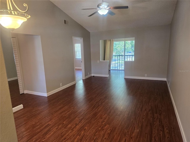 spare room with dark wood-style flooring, a ceiling fan, baseboards, and visible vents