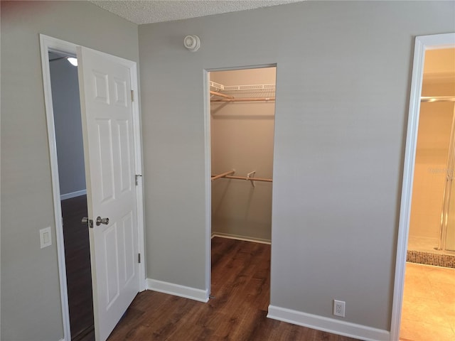 interior space with baseboards and wood finished floors