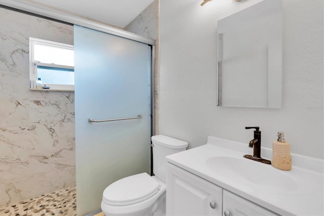 bathroom with toilet, vanity, and an enclosed shower