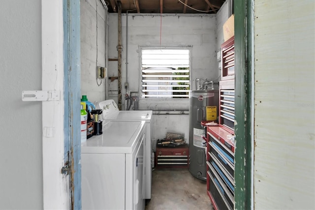 clothes washing area featuring separate washer and dryer and water heater