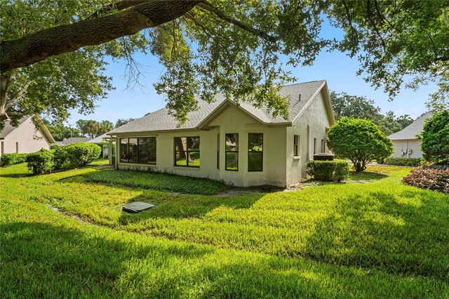 rear view of house with a yard