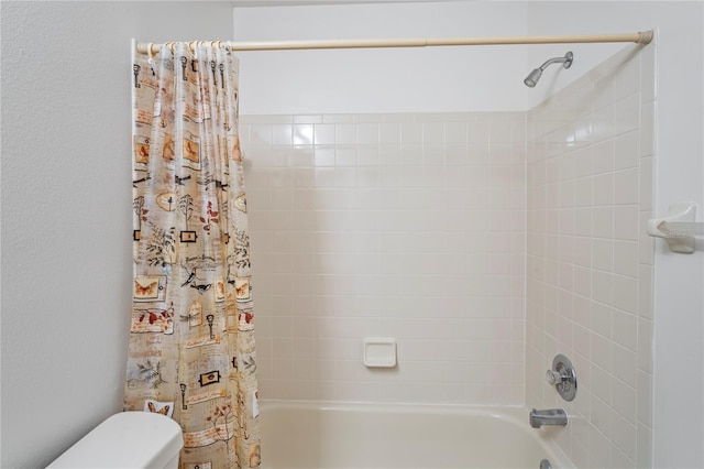 bathroom with toilet and shower / bath combo with shower curtain