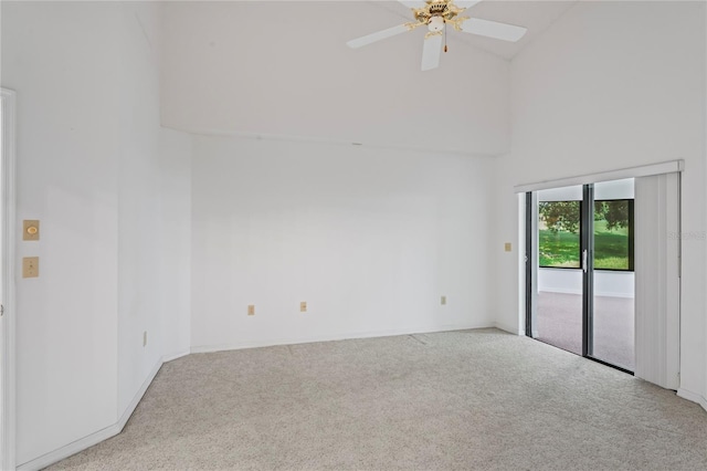 unfurnished room featuring light carpet, high vaulted ceiling, and ceiling fan