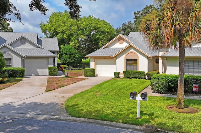 view of front facade featuring a garage and a front lawn