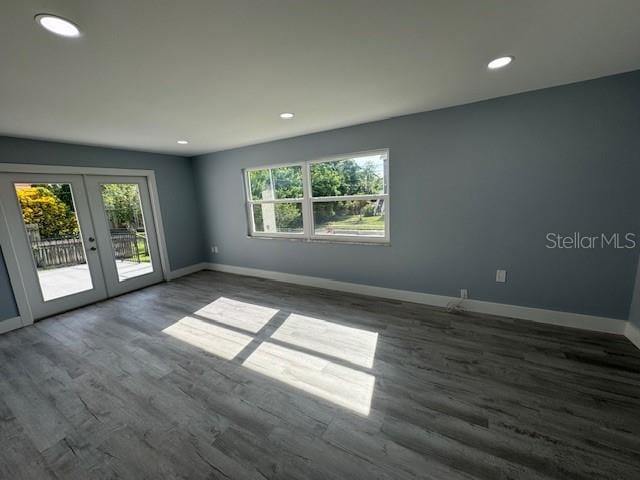 unfurnished room with dark wood-type flooring and french doors