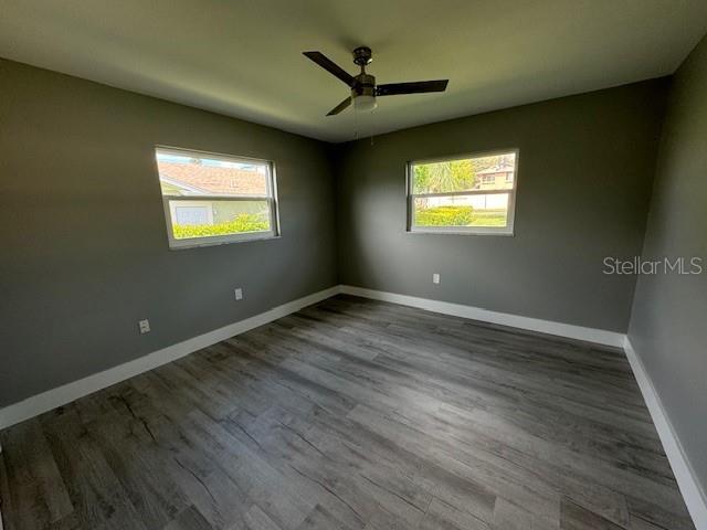 spare room featuring ceiling fan and hardwood / wood-style flooring