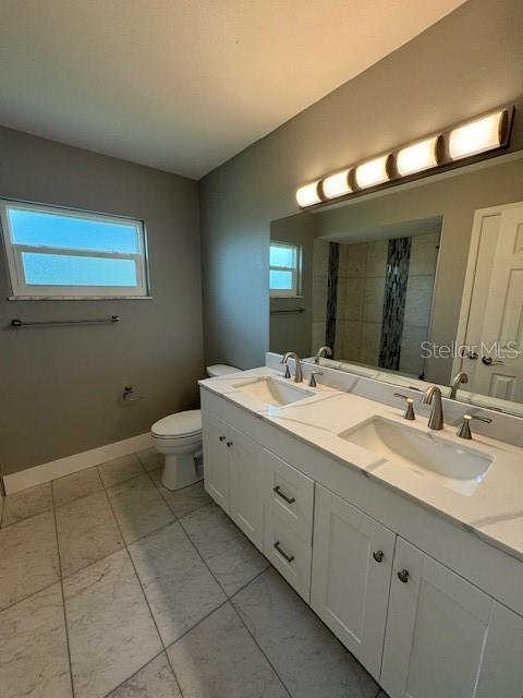 bathroom with vanity, toilet, and a shower with curtain