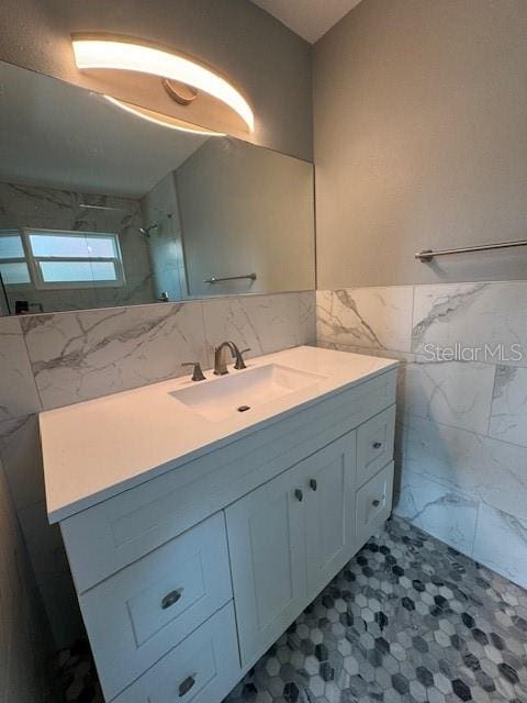 bathroom with vanity, tile walls, and walk in shower