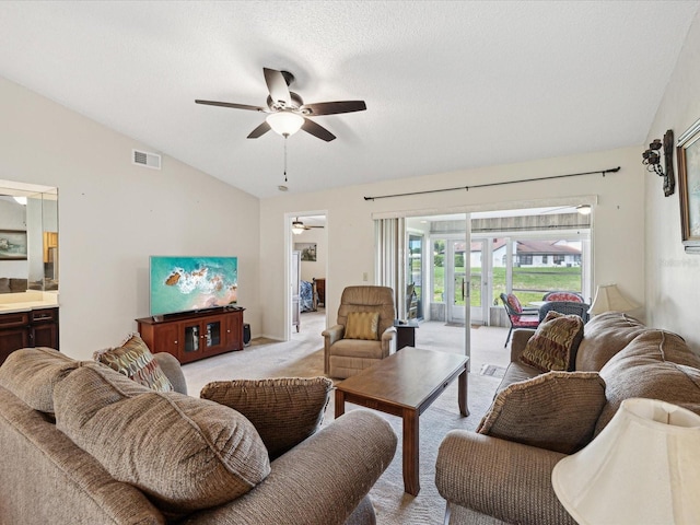 carpeted living room with lofted ceiling, a textured ceiling, and ceiling fan