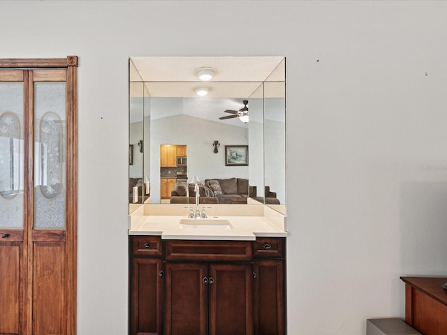 bathroom featuring vanity, vaulted ceiling, and ceiling fan