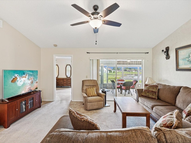 living room featuring vaulted ceiling, light colored carpet, a textured ceiling, and ceiling fan