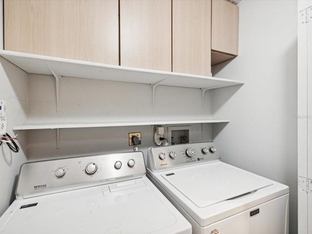 laundry room with cabinets and washer and dryer