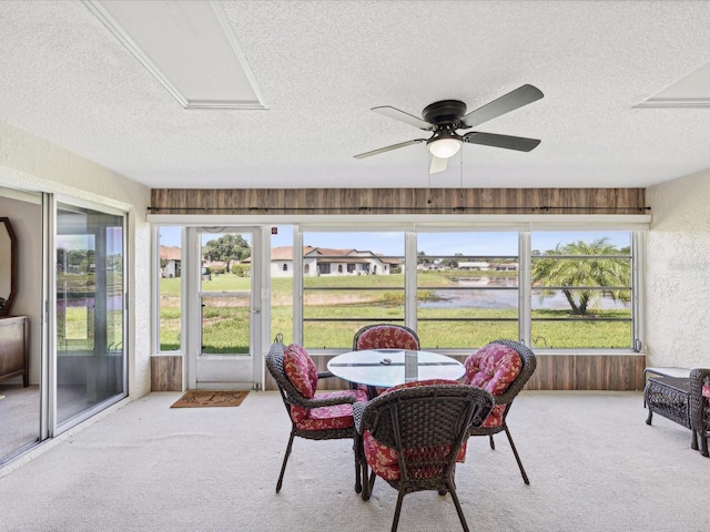 sunroom / solarium featuring ceiling fan