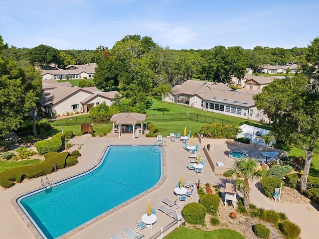 view of swimming pool featuring an outbuilding, a lawn, and a patio