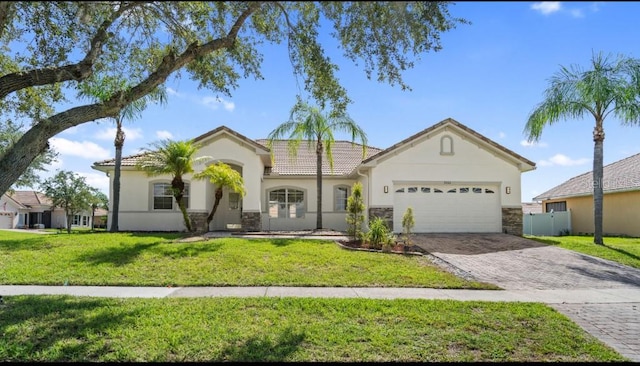 view of front of property with a front yard and a garage