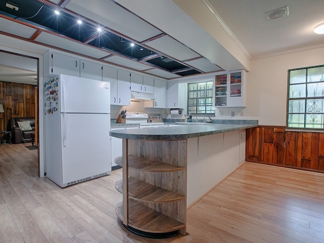 kitchen with crown molding, white appliances, light hardwood / wood-style flooring, and white cabinets