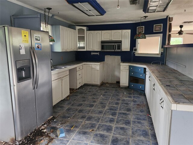 kitchen with visible vents, tile countertops, glass insert cabinets, hanging light fixtures, and stainless steel appliances