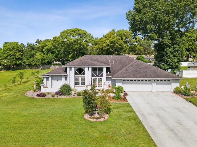 view of front of home with a garage and a front yard