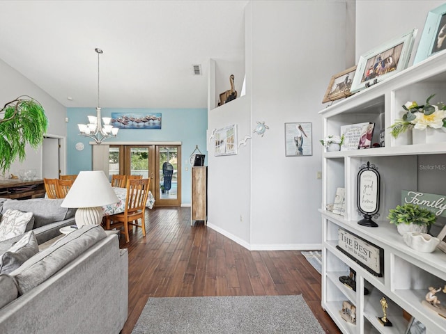 living room with an inviting chandelier, dark hardwood / wood-style flooring, and high vaulted ceiling