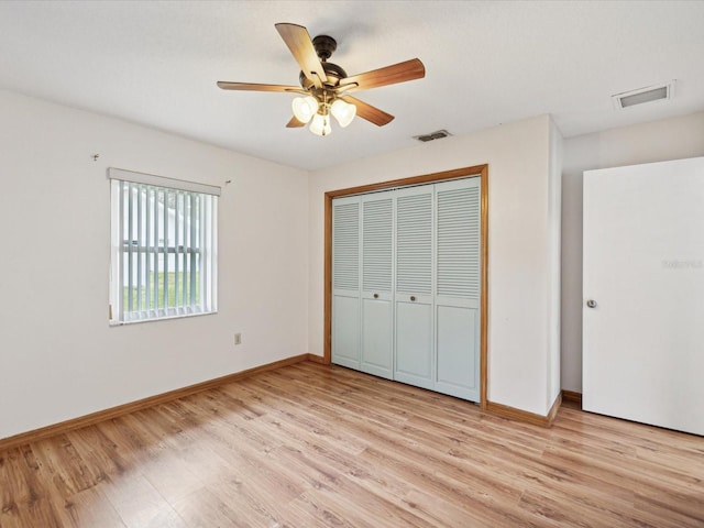 unfurnished bedroom featuring a closet, ceiling fan, and light wood-type flooring