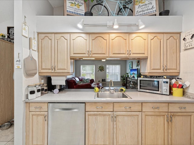 kitchen featuring appliances with stainless steel finishes, sink, and light brown cabinets