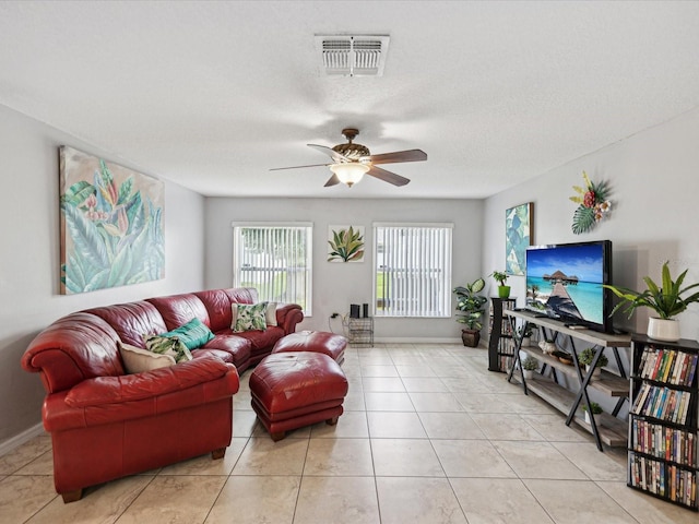 tiled living room featuring a textured ceiling and ceiling fan