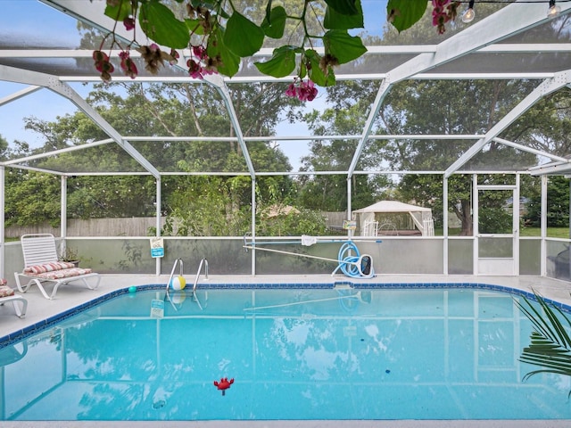 view of pool with glass enclosure