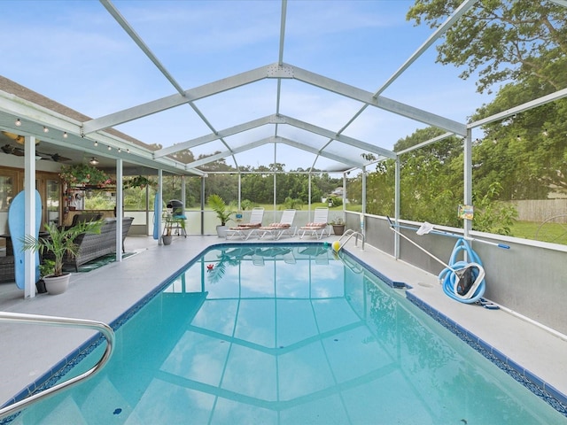 view of pool with a lanai, a patio area, and ceiling fan