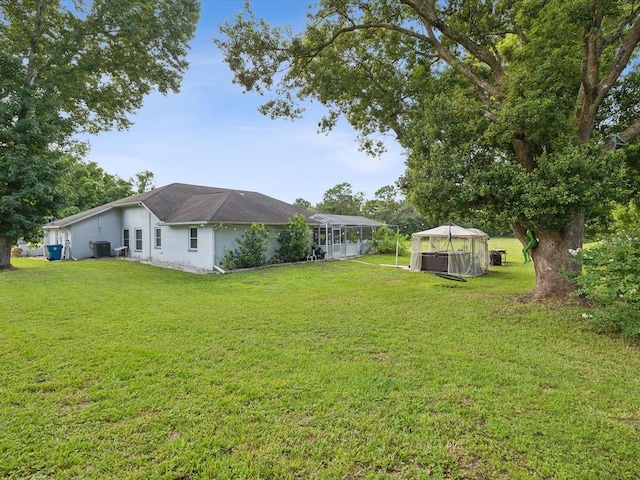 view of yard with a gazebo and central AC