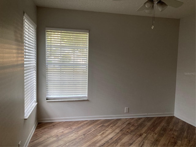 spare room with a textured ceiling, ceiling fan, and hardwood / wood-style floors