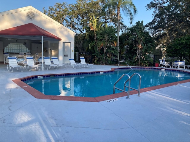 view of swimming pool with a patio area