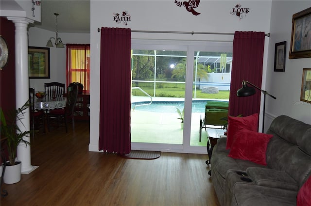 doorway featuring decorative columns and hardwood / wood-style flooring