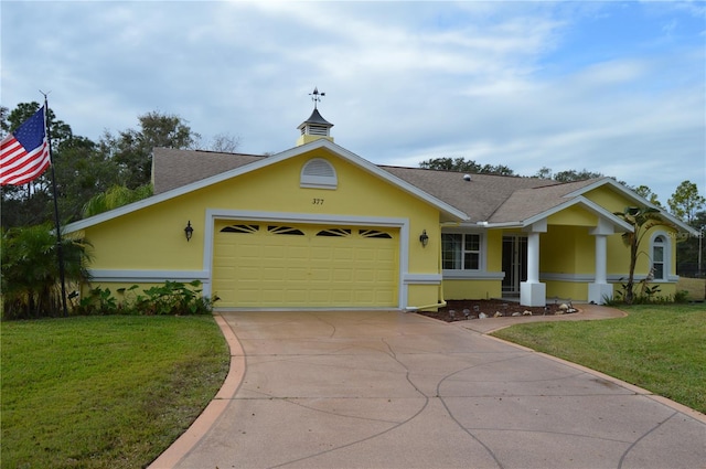 view of front of house with a garage and a front yard