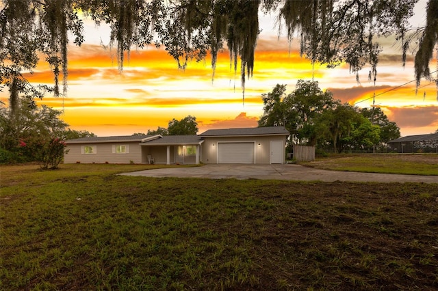 view of front facade with a yard and a garage