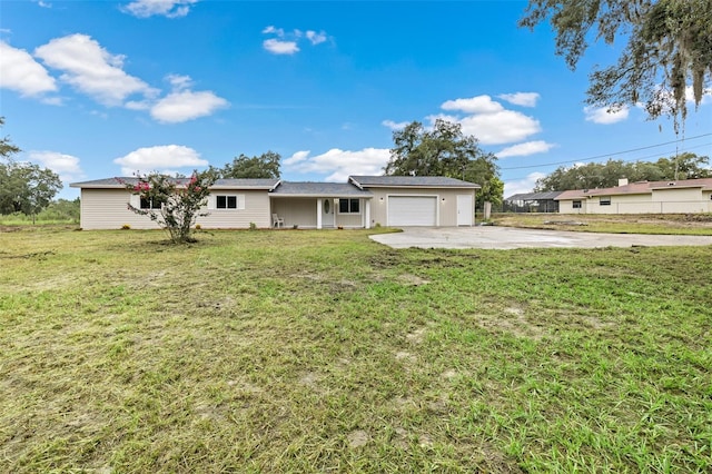 single story home with a front yard and a garage